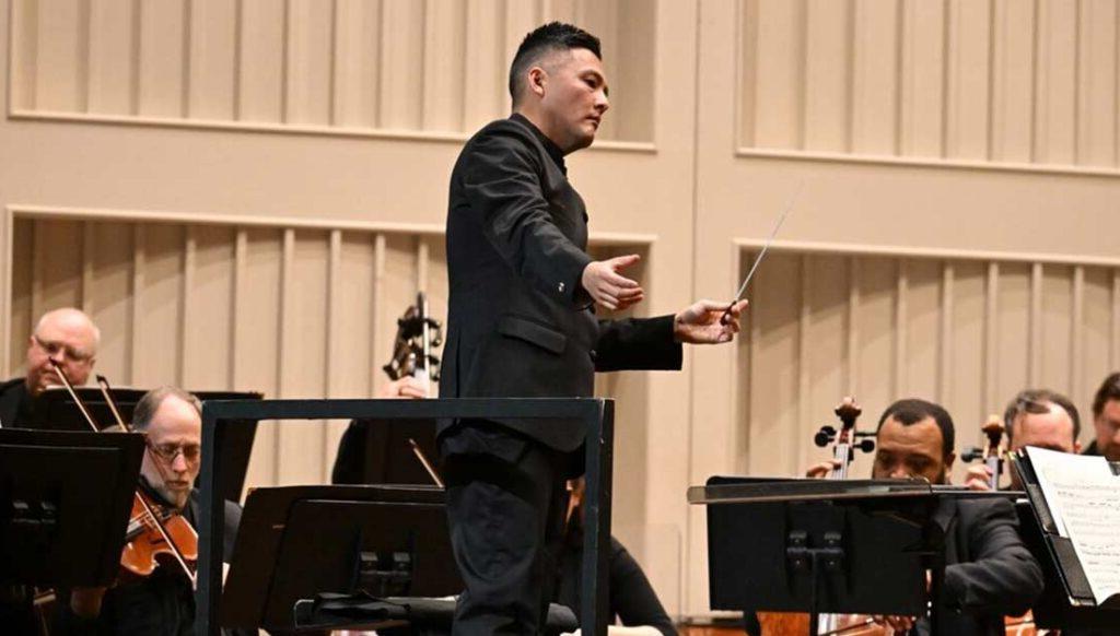 A conductor orchestrates Symphonie Fantastique